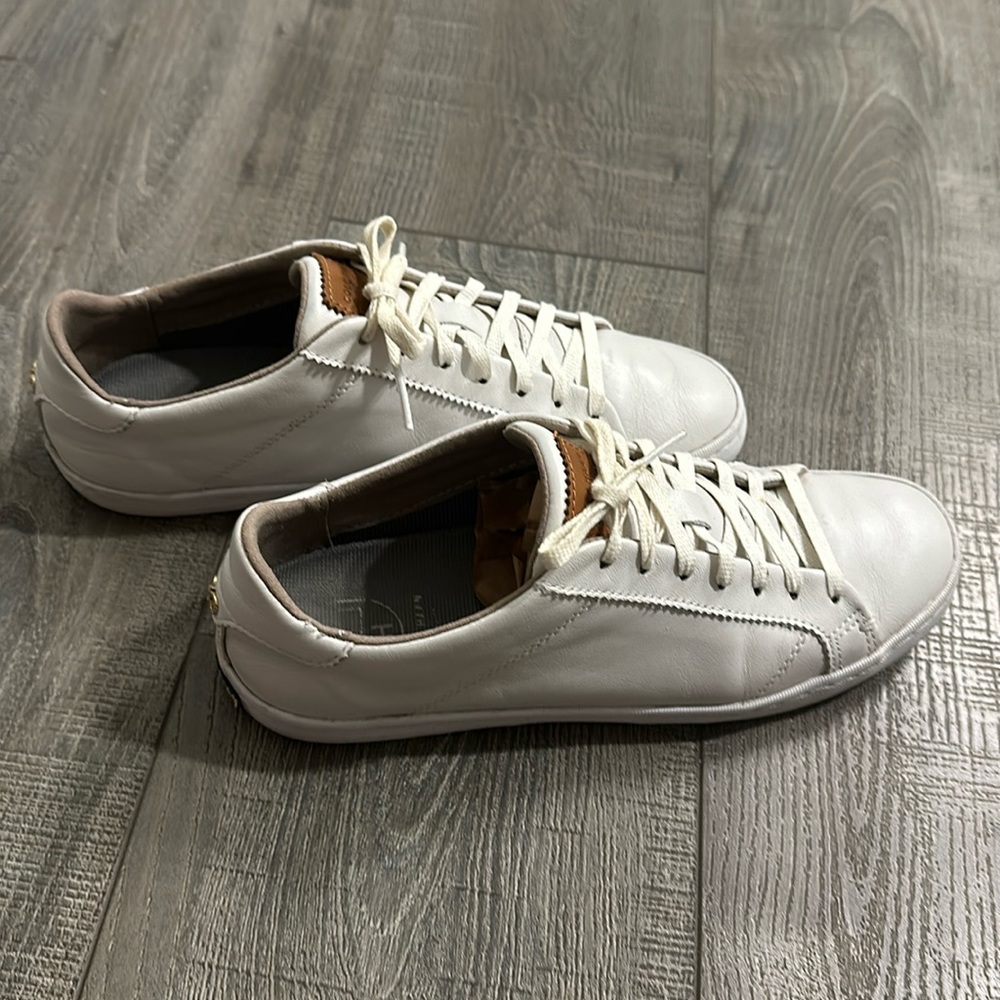 White leather sneakers by Cole Haan, in good used condition. No rips/tears.